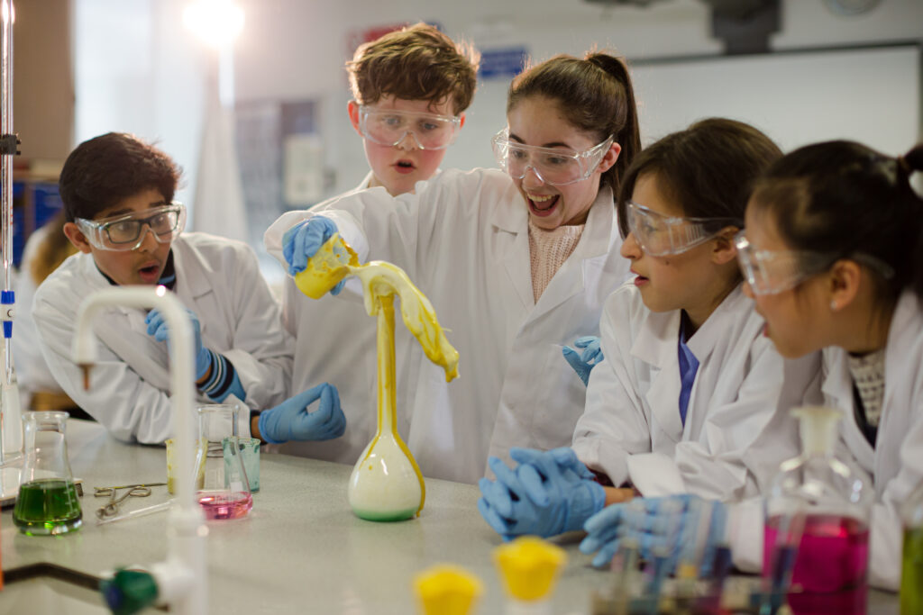 Surprised students conducting exploding foam scientific experime